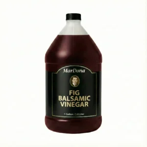 A 1-gallon jug of MarDona Fig Balsamic Vinegar showing a deep, dark purple-brown color.