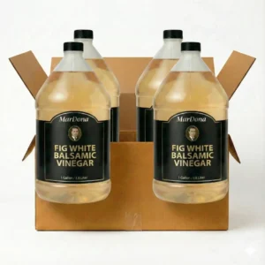 A wholesale case of four 1-gallon jugs of MarDona Fig White Balsamic Vinegar in a cardboard shipping box.