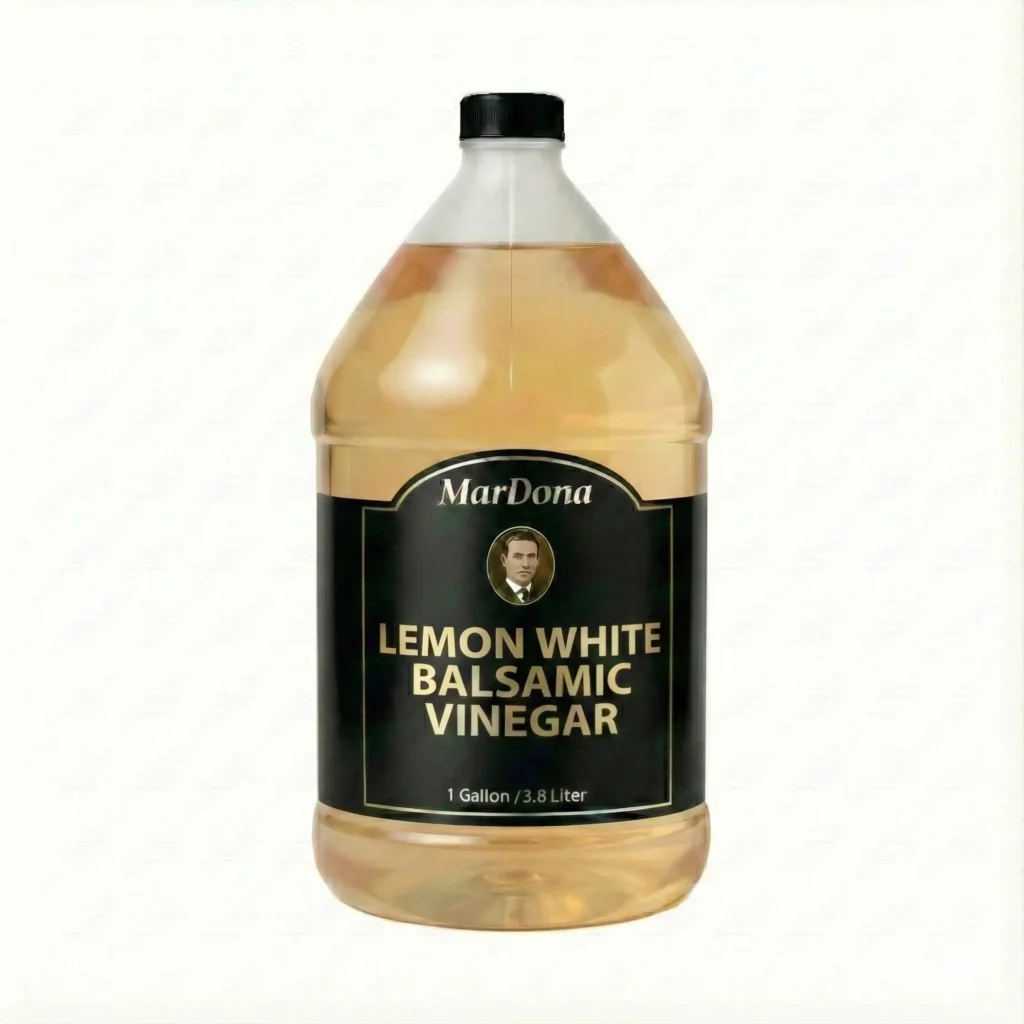 A 1-gallon jug of MarDona Lemon White Balsamic Vinegar, 3.8 Liters, in a clear plastic container with a black and gold label.