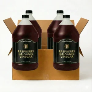 A cardboard shipping case containing four 1-gallon jugs of MarDona Raspberry Balsamic Vinegar.