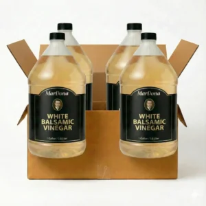 A cardboard shipping case containing four 1-gallon jugs of MarDona White Balsamic Vinegar.